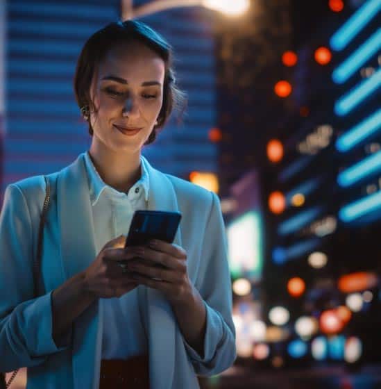 Image of a woman using a Qorbis banking app on her mobile phone