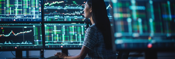 Image of a woman viewing trading screens and dashboards
