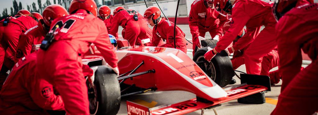 Image of a Ferrari F1 Pit Crew and Car