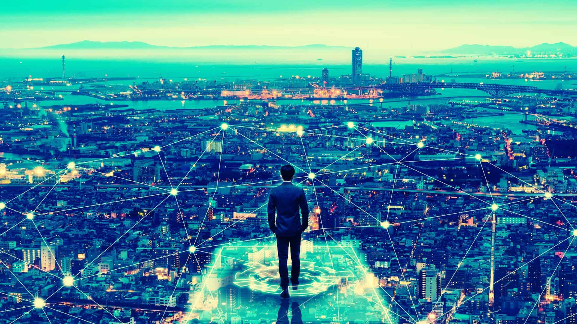 Businessman looking out over city skyline.